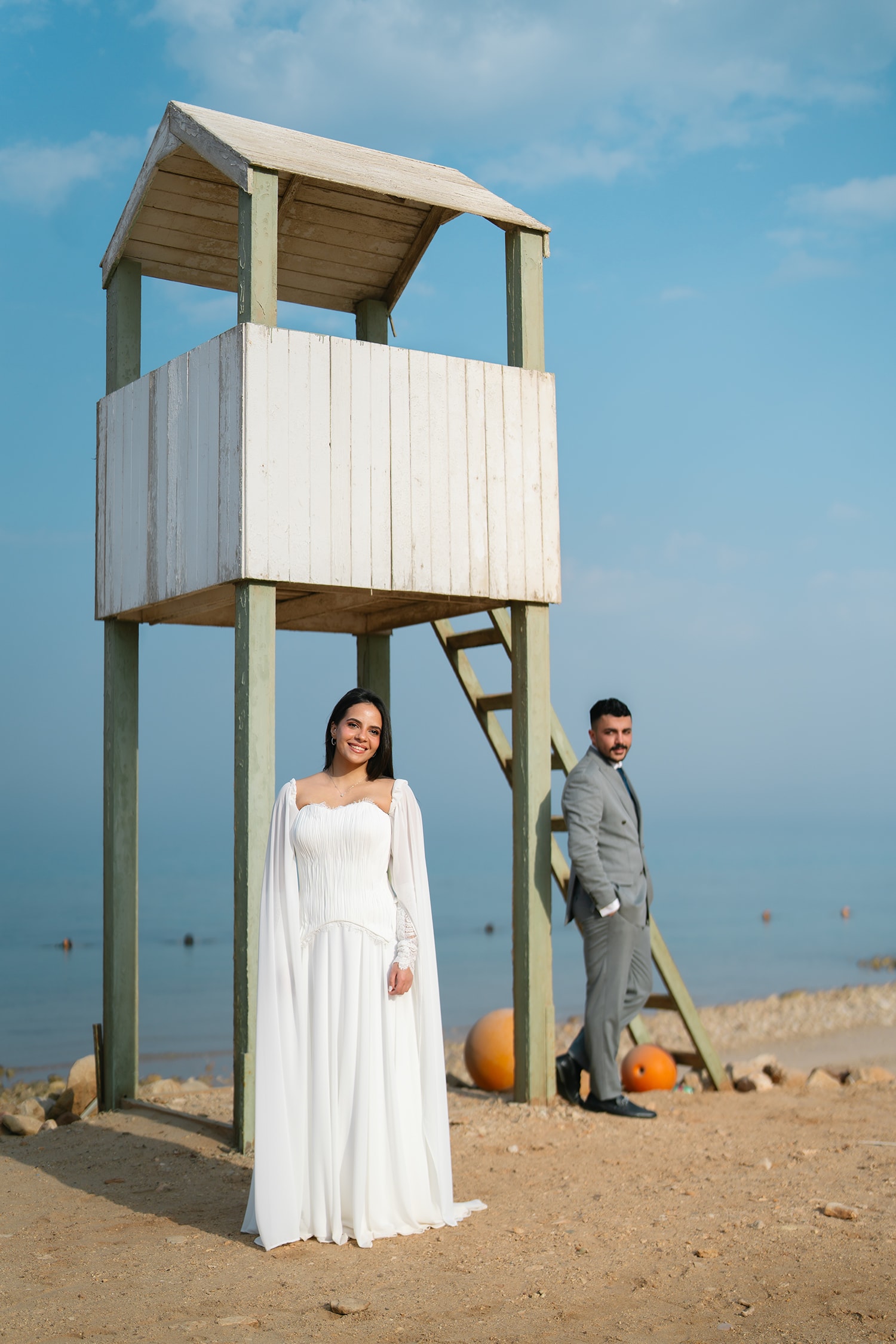 Couple posing beach lifeguard tower