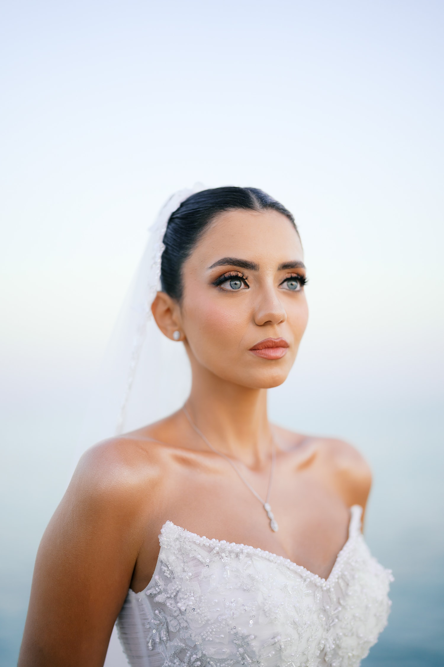 Woman in white wedding dress veil