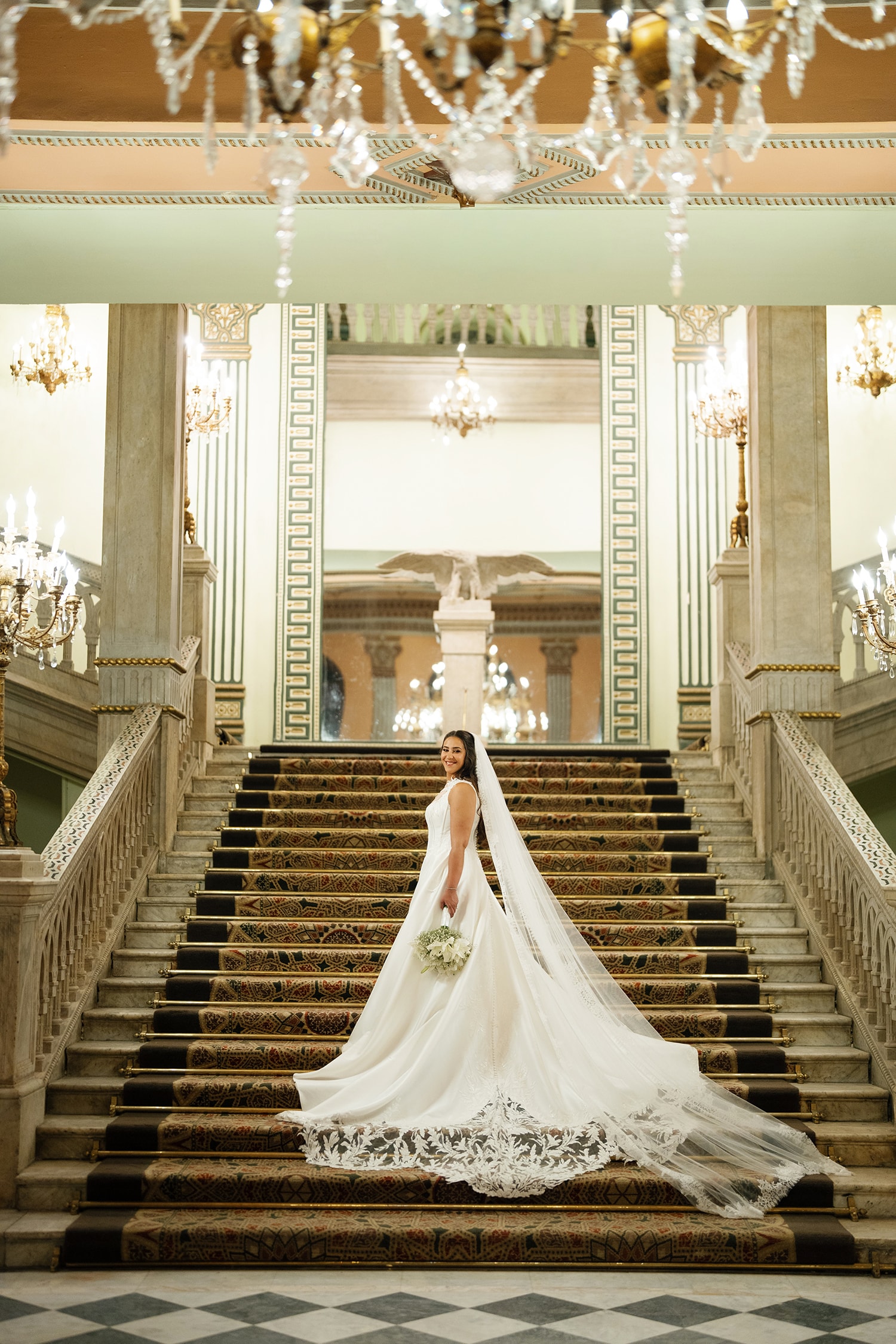 Bride in white gown grand staircase