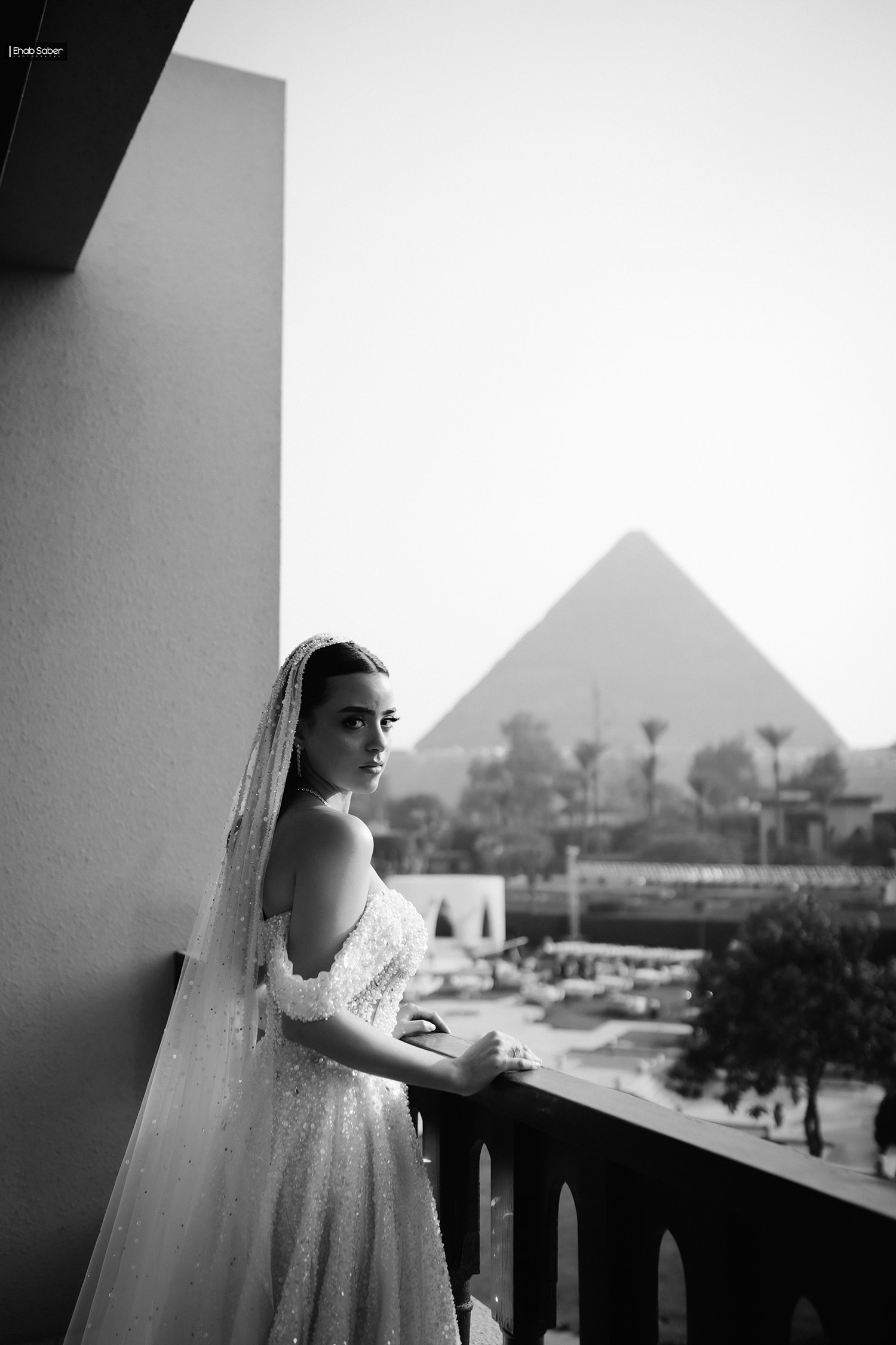 Bride in wedding dress overlooking pyramid