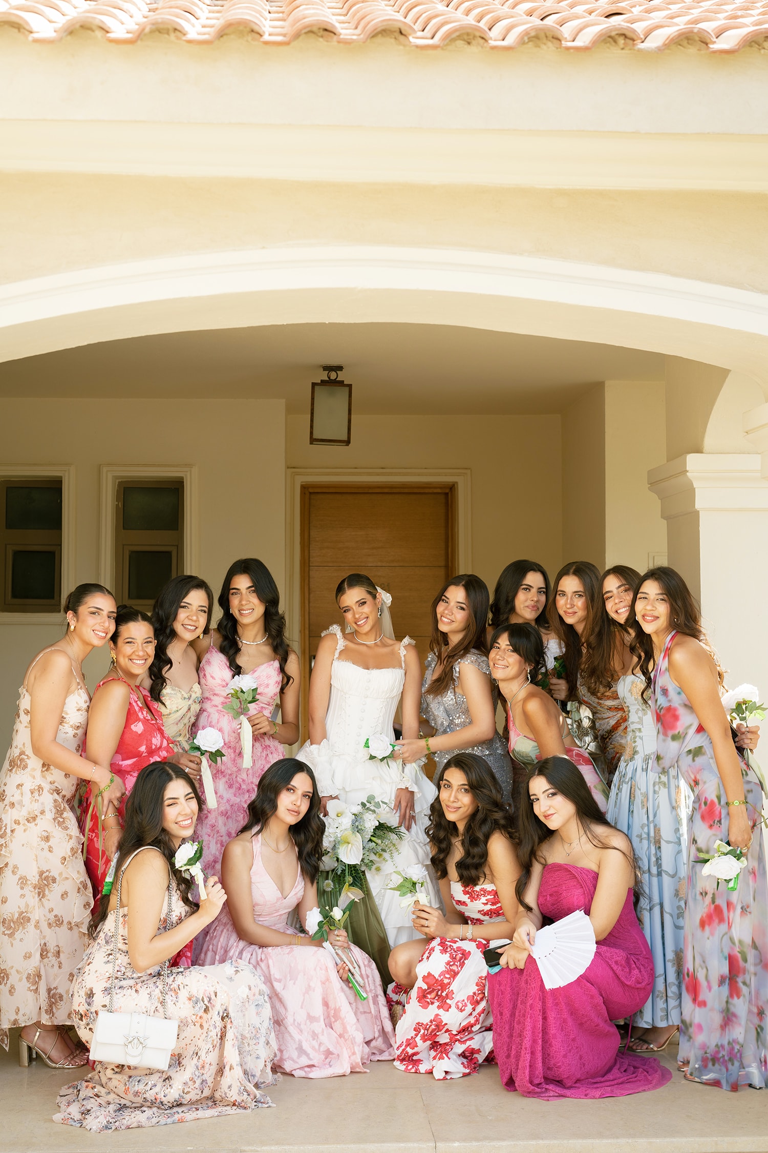Bride and bridesmaids holding flowers together