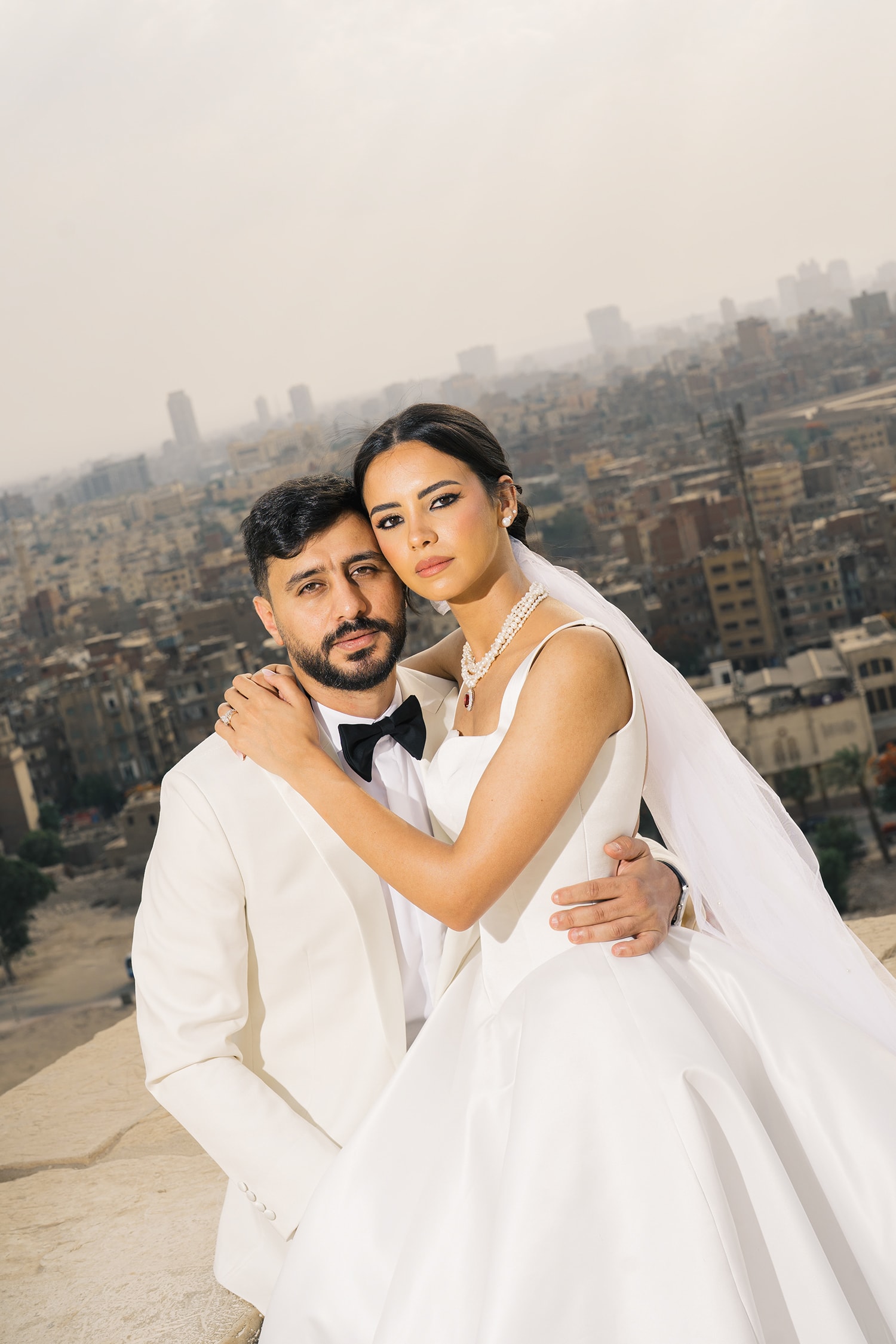 Bride groom rooftop city skyline portrait