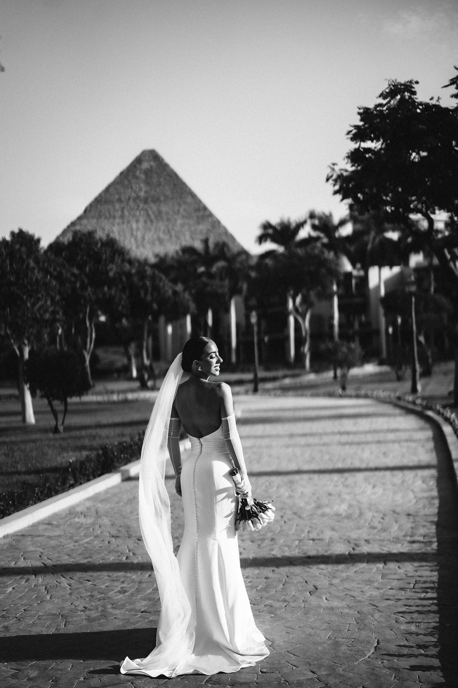 Bride groom posing ornate building backdrop