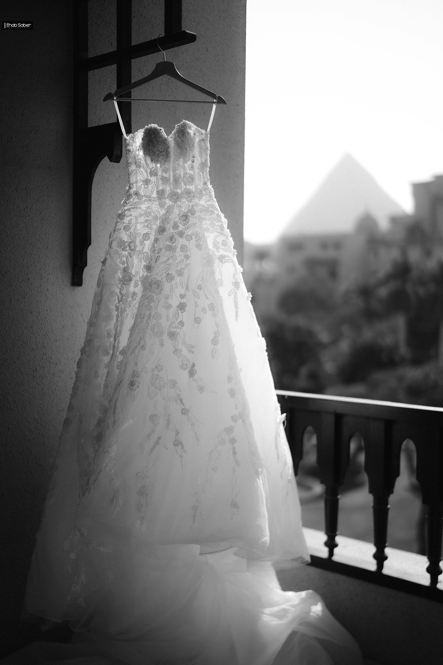 Ornate wedding dress hanging on hanger