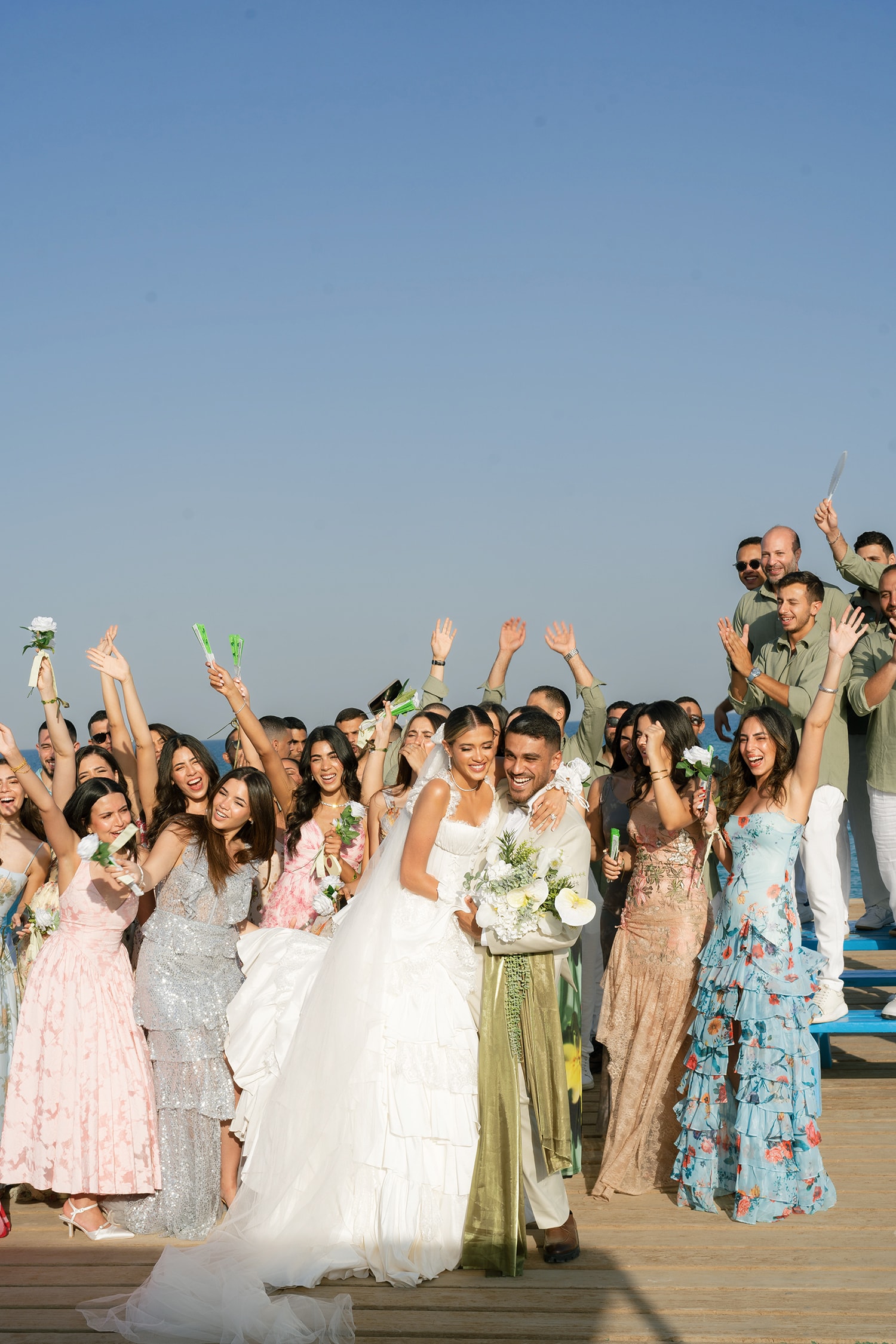 Bride groom celebrating with wedding guests outdoors